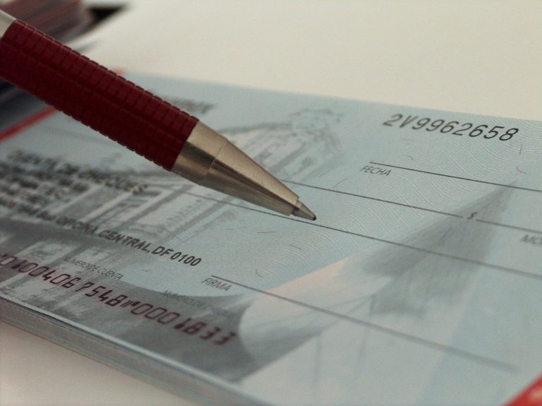 Person writing a check - from freeimages.com